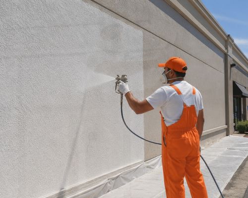 applying elastomeric coating to stucco commercial building in Hayward